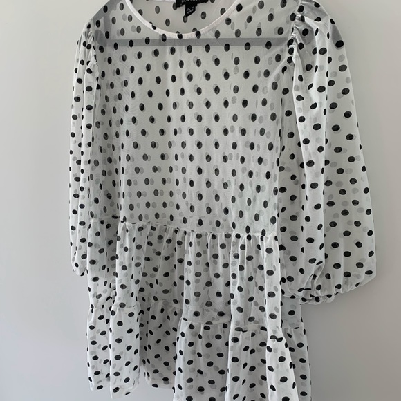 Mesh polka dot peplum, puff sleeve top in black and white. - Picture 3 of 3